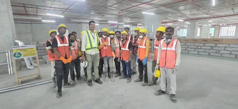 Mohammed Shareef, Founder and Proprietor of The Wall Fashion, with the civil team on a commercial site