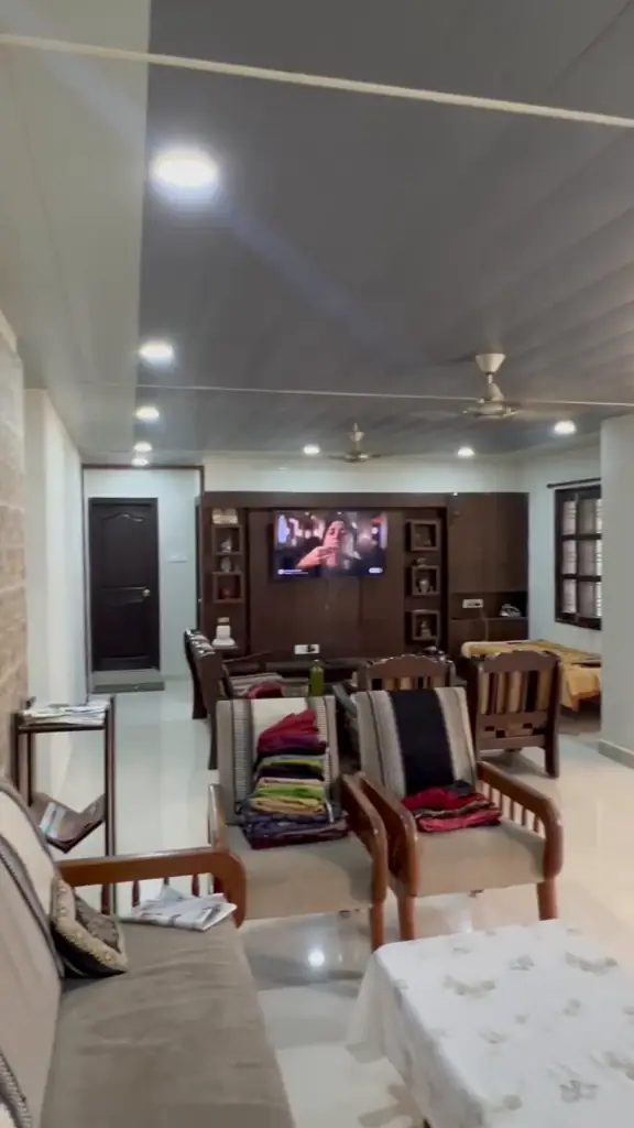 Living room with wooden panel false ceiling, spotlights and profile lighting