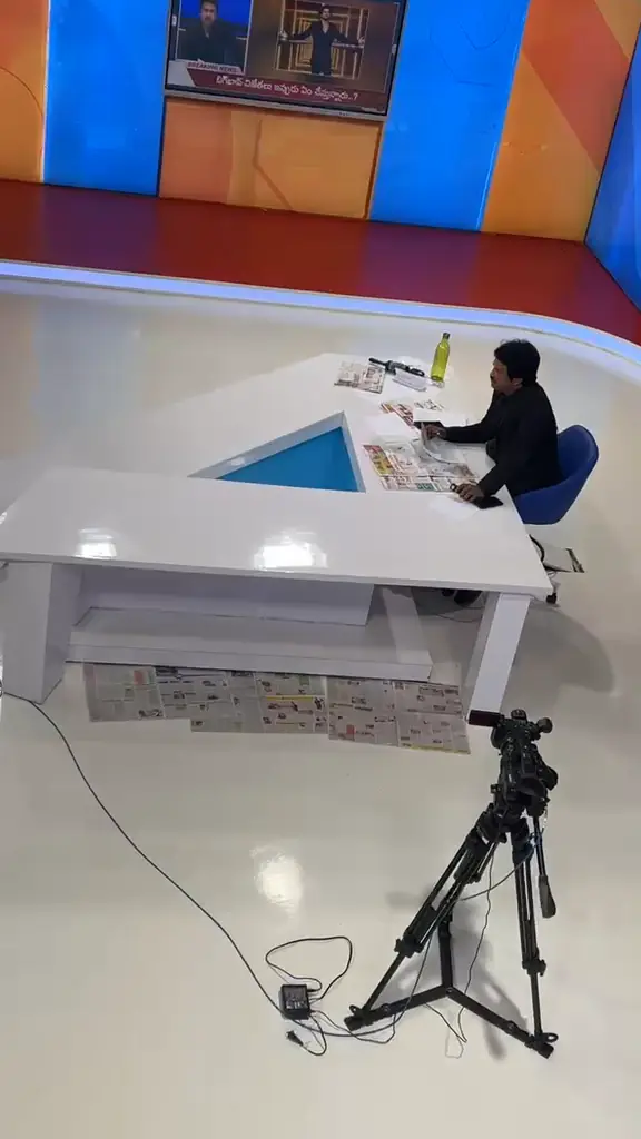 Anchor presenting live at a news desk built by The Wall Fashion