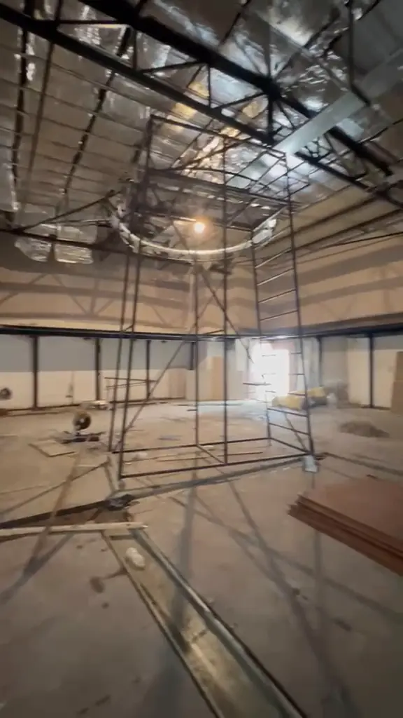 Empty studio shell with steel structure, lighting grid and scaffolding
